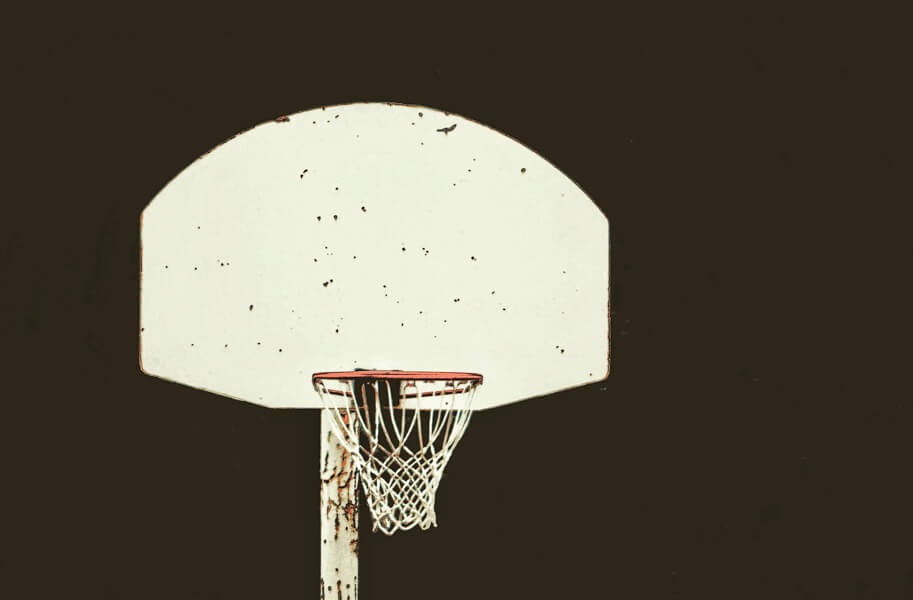 Wooden basketball hoop against a night sky